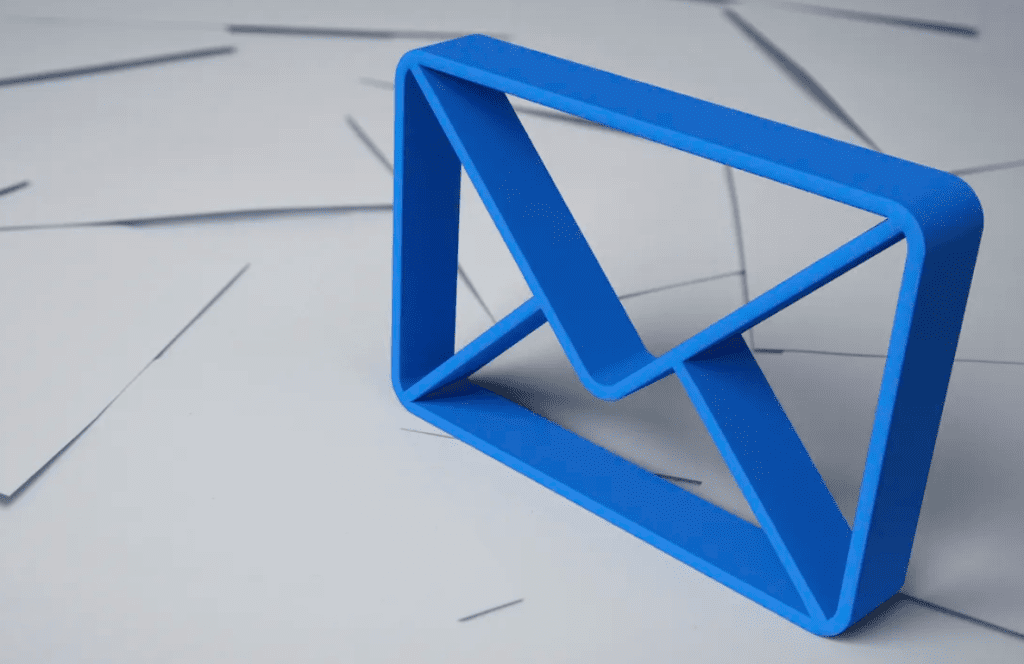 A three dimensional blue outline of an envelope standing on top of a mess of white envelopes