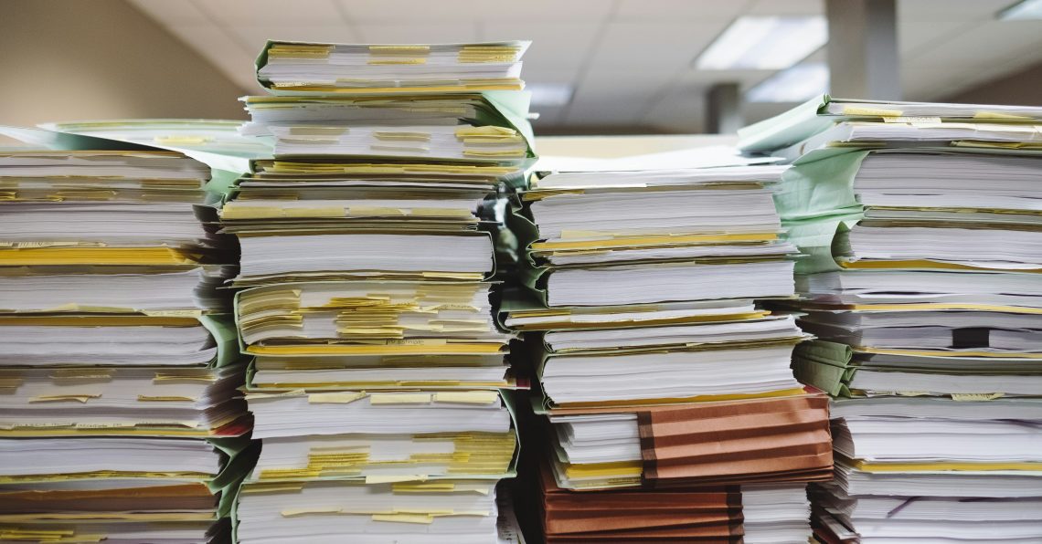 piles of messy, over-packed files in a row