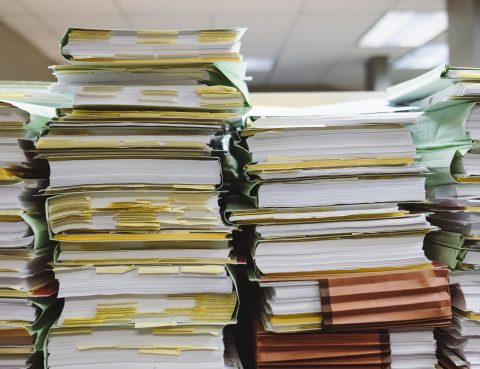 piles of messy, over-packed files in a row