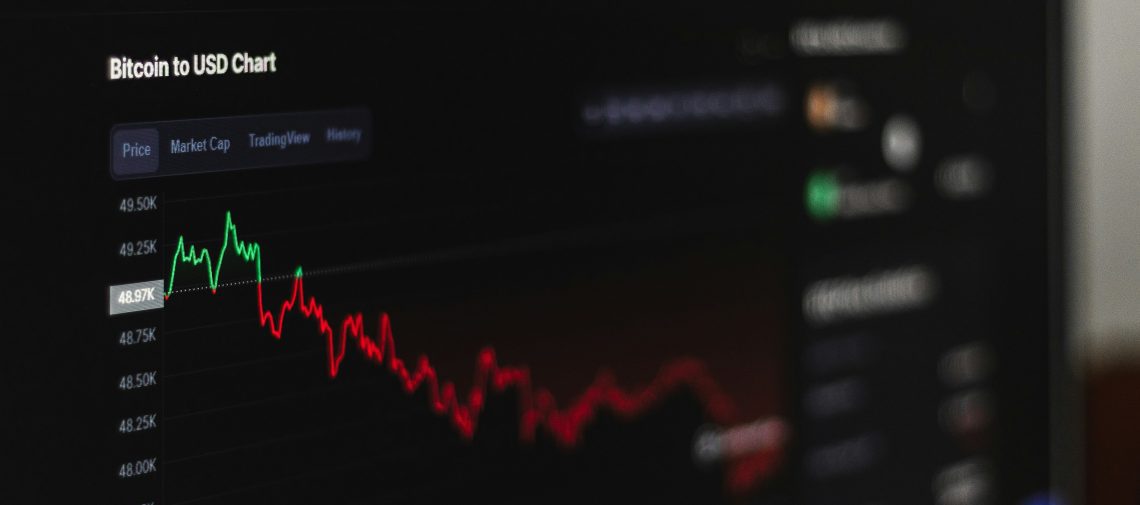 computer screen with a line chart showing crypto investment on the decline