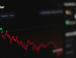 computer screen with a line chart showing crypto investment on the decline