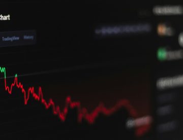 computer screen with a line chart showing crypto investment on the decline