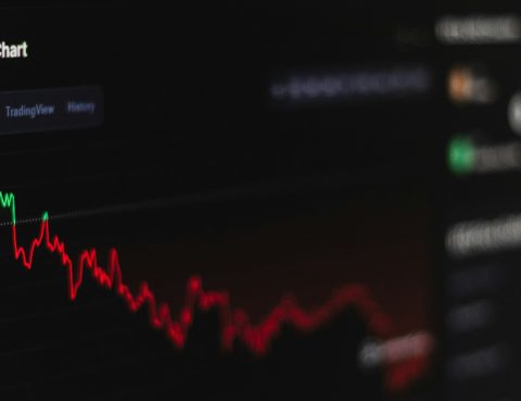 computer screen with a line chart showing crypto investment on the decline